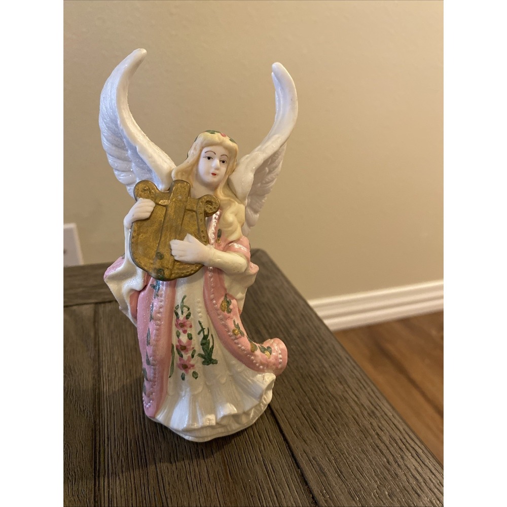 Vintage porcelain angel figurine playing a harp